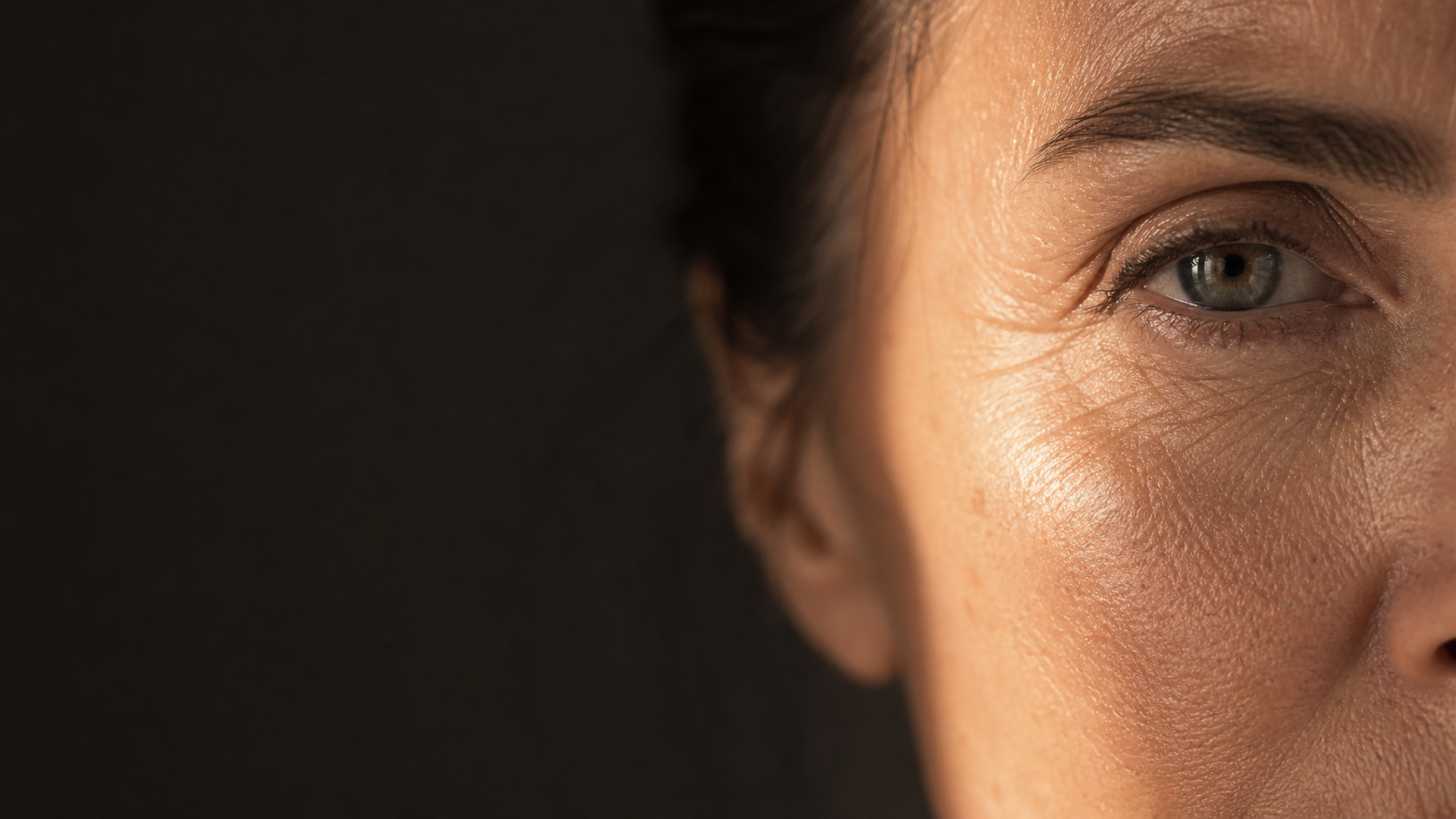Close-up of mature skin around the eye in warm natural light